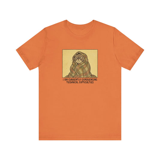 Orange t-shirt with a cat wrapped in a blanket saying "I am currently experiencing technical difficulties."
