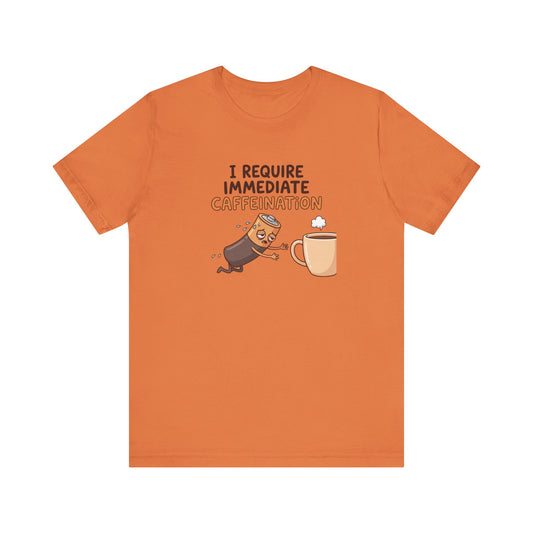 Orange t-shirt with cartoon battery and coffee cup, text "I REQUIRE IMMEDIATE CAFFEINATION".