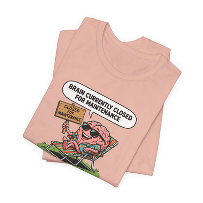 Peach t-shirt with a cartoon brain wearing sunglasses relaxing in a chair, text reads "BRAIN CURRENTLY CLOSED FOR MAINTENANCE".