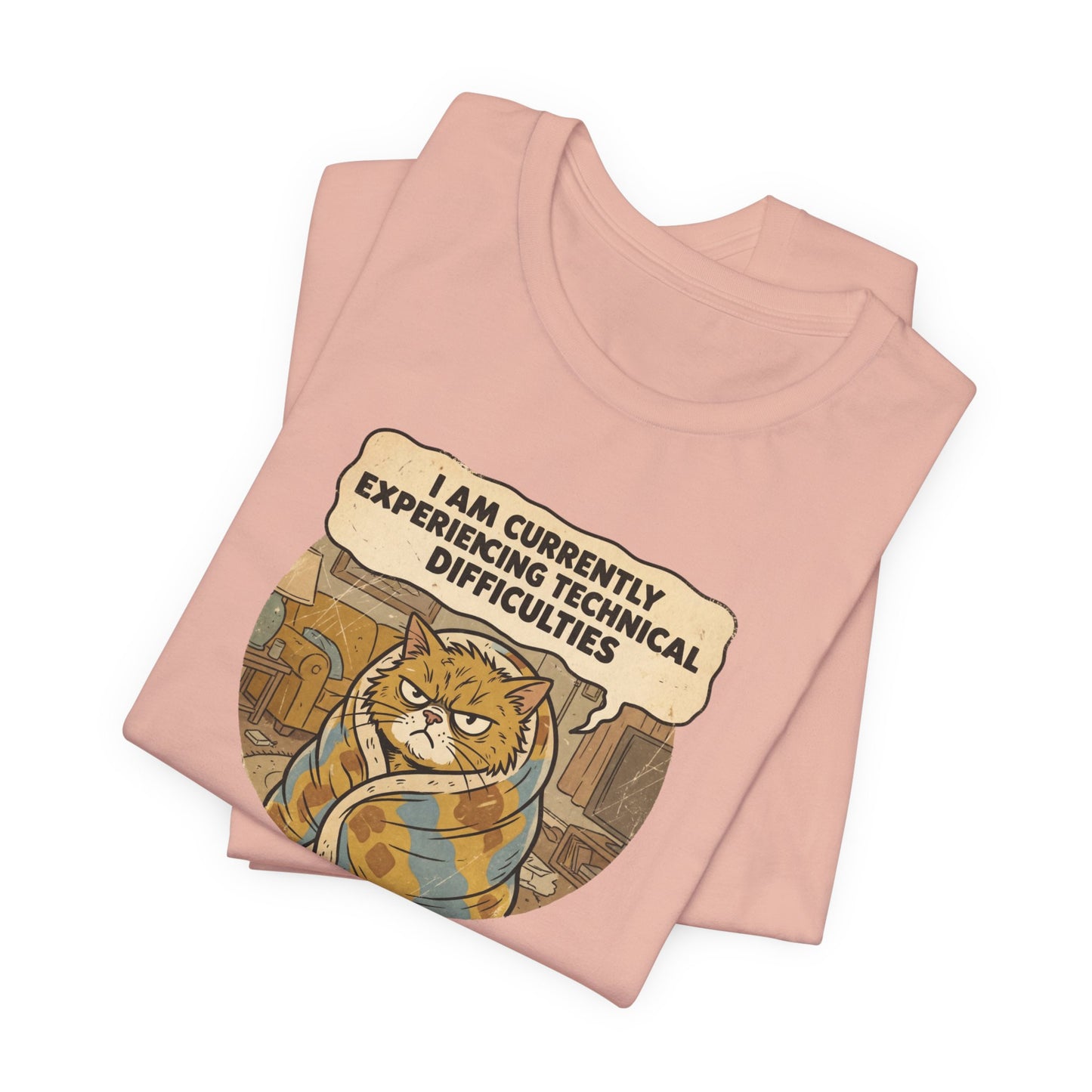 Pink t-shirt with graphic of a grumpy cat wrapped in a blanket saying "I AM CURRENTLY EXPERIENCING TECHNICAL DIFFICULTIES".