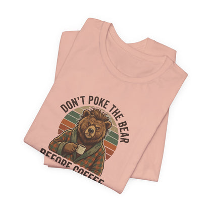 Pink t-shirt with graphic of a bear drinking coffee and text "DON'T POKE THE BEAR BEFORE COFFEE".