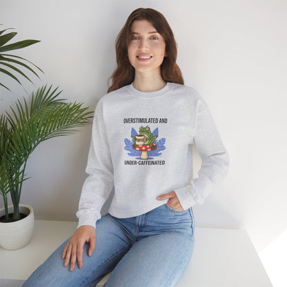 Light gray sweatshirt with graphic of frog and text "OVERSTIMULATED AND UNDER-CAFFEINATED".