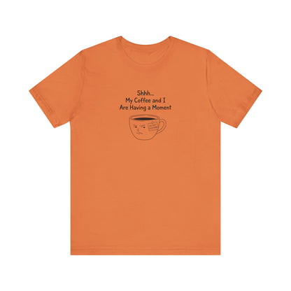 Orange t-shirt with text "Shhh... My Coffee and I Are Having a Moment" and a disgruntled coffee cup.