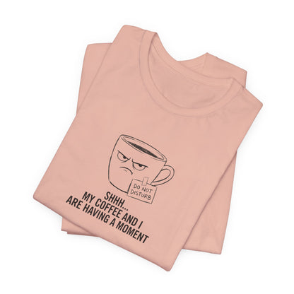 Pink t-shirt with a grumpy coffee cup graphic saying "SHHH... MY COFFEE AND I ARE HAVING A MOMENT."