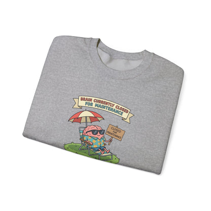 Gray sweatshirt with a cartoon brain relaxing under an umbrella, "Brain Currently Closed For Maintenance" text.