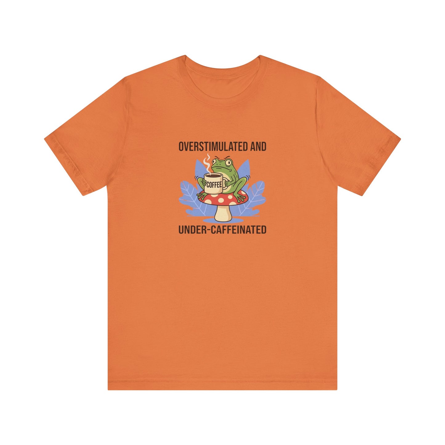 T-shirt with frog wearing glasses, holding coffee cup, with text "Overstimulated and Under-caffeinated".