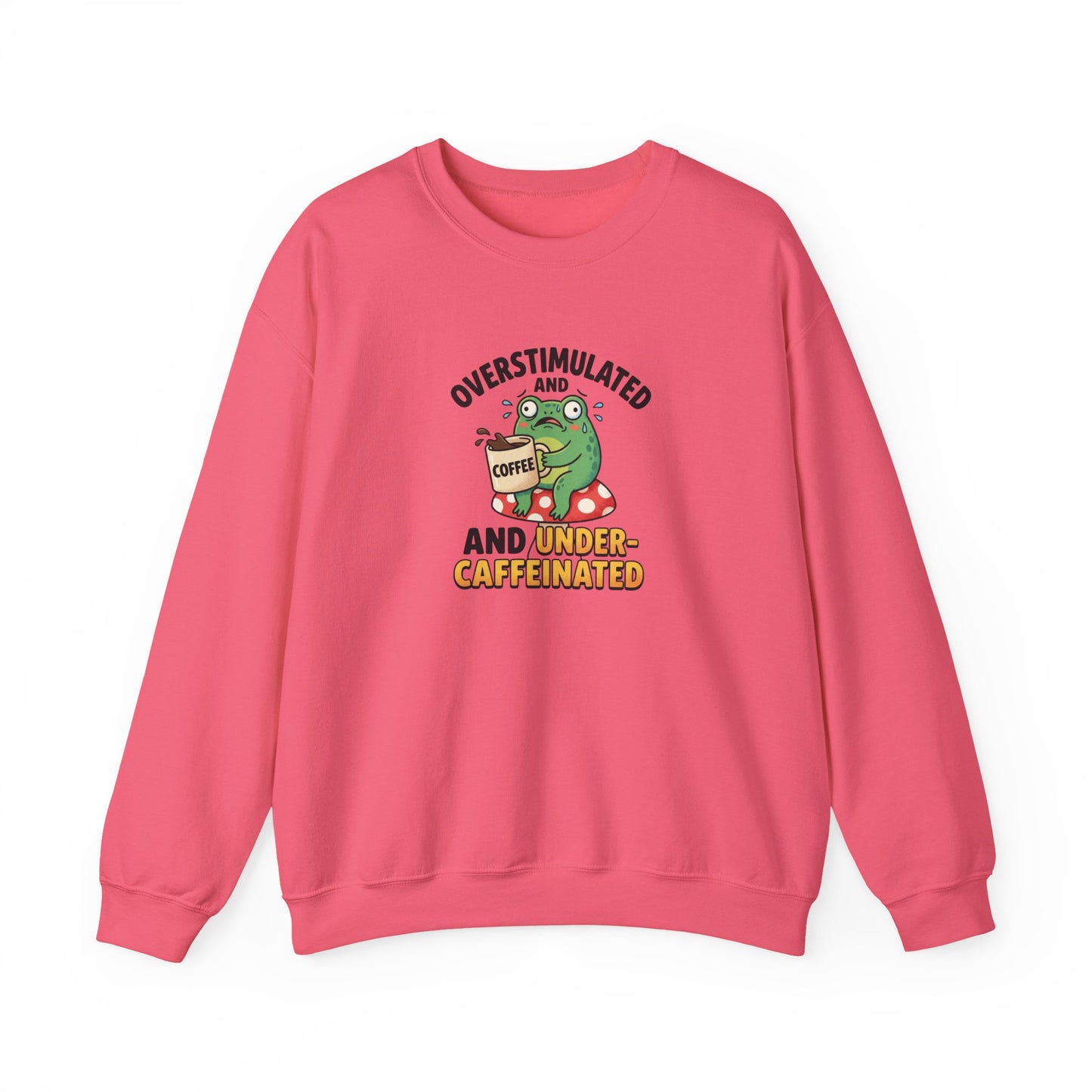 Green frog holding coffee cup on mushroom, text "OVERSTIMULATED AND UNDER-CAFFEINATED".