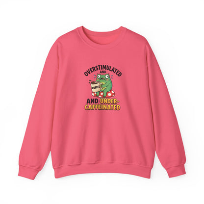 Green frog holding coffee cup on mushroom, text "OVERSTIMULATED AND UNDER-CAFFEINATED".