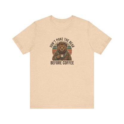 T-shirt with a bear wearing pajamas holding a coffee mug, text reads "Don't poke the bear before coffee."