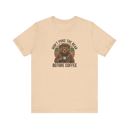 T-shirt with a bear wearing pajamas holding a coffee mug, text reads "Don't poke the bear before coffee."