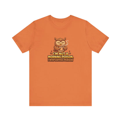 Orange t-shirt with owl holding coffee cup and text: I'm not a morning person, I'm a coffee person.