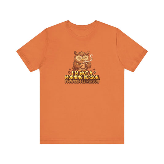 Orange t-shirt with owl holding coffee cup and text: I'm not a morning person, I'm a coffee person.