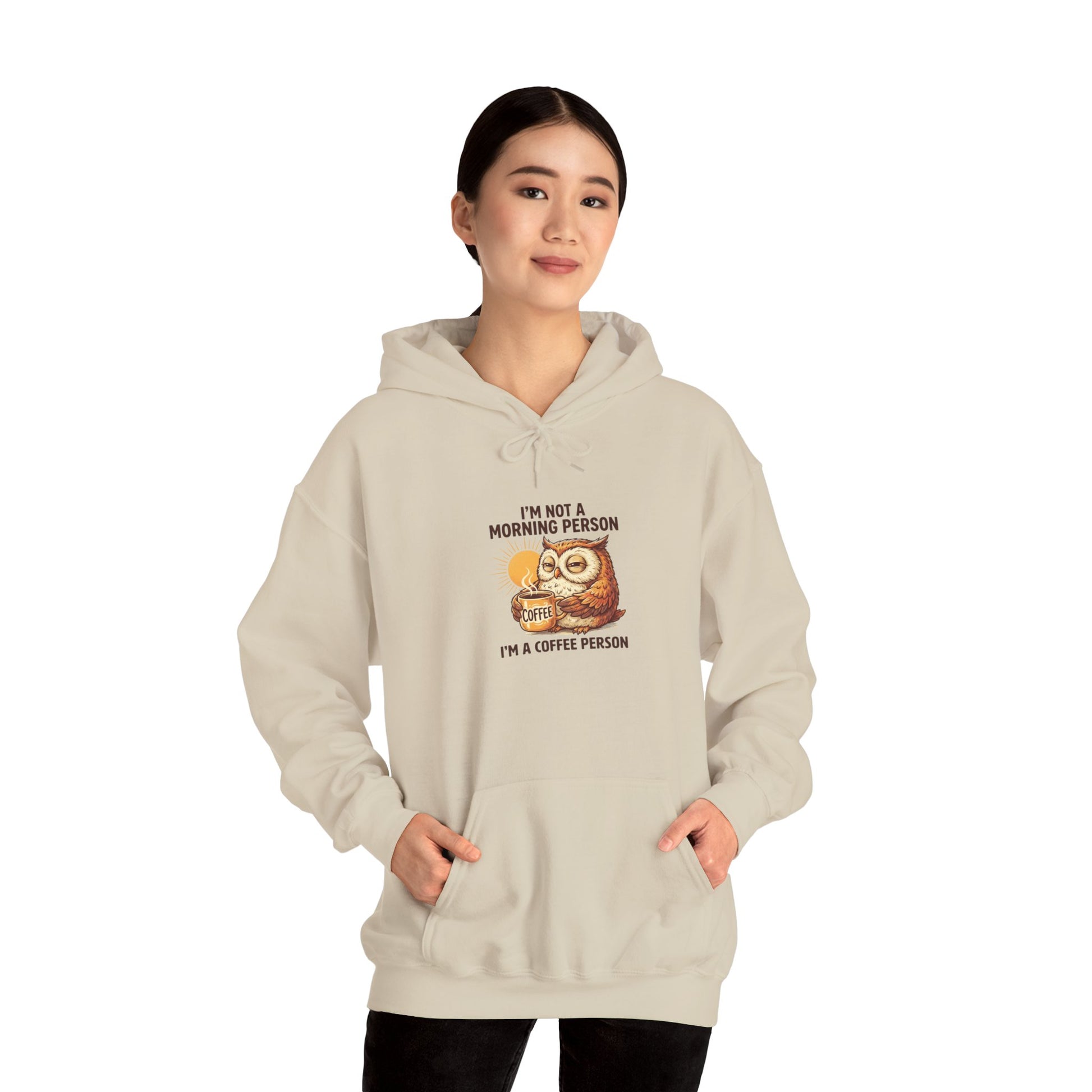 Beige hooded sweatshirt with owl drinking coffee and text, "I'm not a morning person, I'm a coffee person."