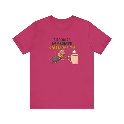 Battery character leaning towards a steaming mug of coffee with text "I REQUIRE IMMEDIATE CAFFEINATION".