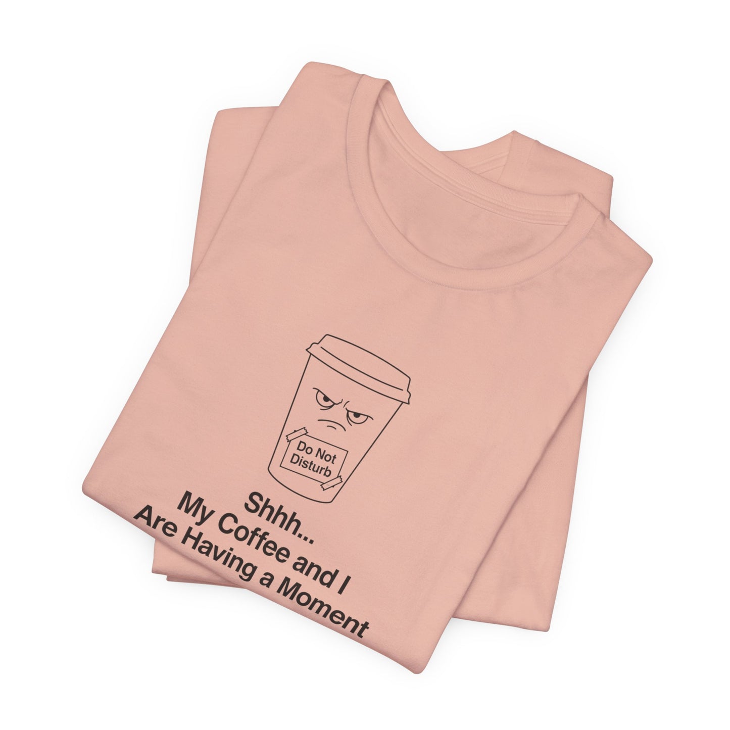 Peach t-shirt with a grumpy coffee cup graphic and text.