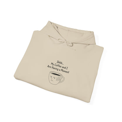 Cream hoodie with "Shhh... My Coffee and I Are Having a Moment" and frowning coffee cup design.