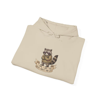 Tan hoodie with a raccoon wearing a banner that reads "I came, I saw, I had social anxiety and left."