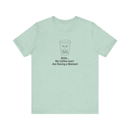 Light teal t-shirt with black line drawing of coffee cup and text "Shhh... My Coffee and I Are Having a Moment."