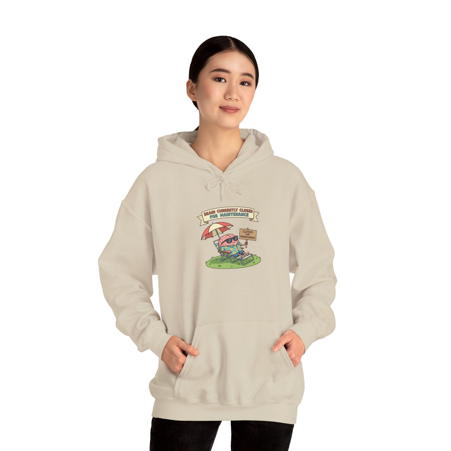 Cream hoodie with cartoon brain relaxing under umbrella, "Brain Closed for Maintenance" sign.