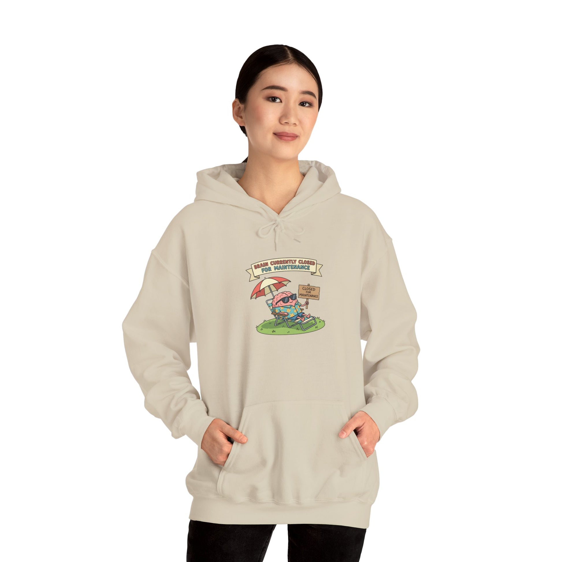 Cream hoodie with cartoon brain relaxing under umbrella, "Brain Closed for Maintenance" sign.