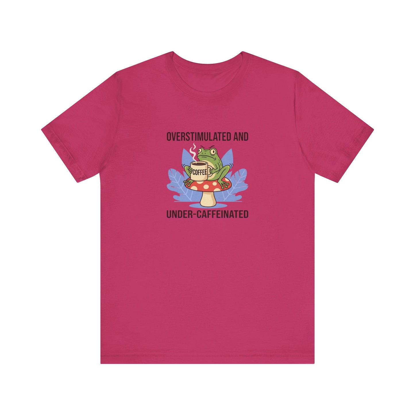 T-shirt with a frog on a mushroom holding a coffee cup, text reads "Overstimulated and Under-Caffeinated".
