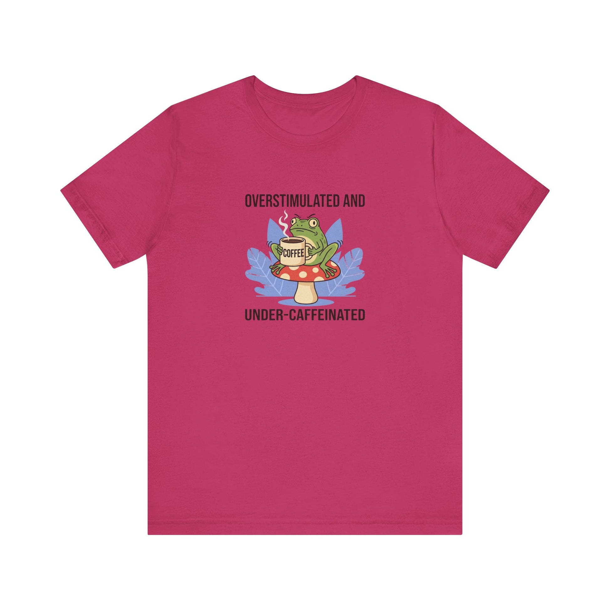 T-shirt with a frog on a mushroom holding a coffee cup, text reads "Overstimulated and Under-Caffeinated".