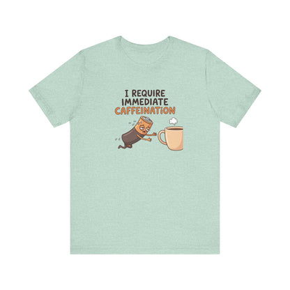 T-shirt with text "I REQUIRE IMMEDIATE CAFFEINATION" and a cartoon character reaching for coffee.