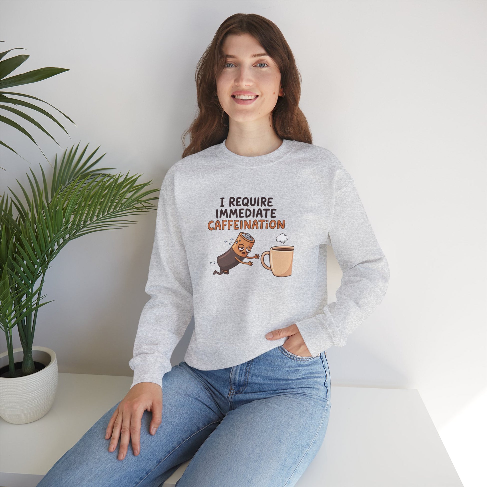 Light gray sweatshirt with cartoon text "I require immediate caffeination" and coffee cup.