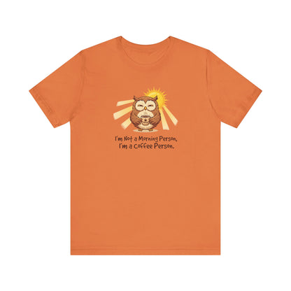 Orange t-shirt with cartoon owl holding coffee, sun behind it, text: "I'm Not a Morning Person, I'm a Coffee Person."