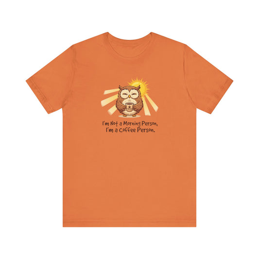 Orange t-shirt with cartoon owl holding coffee, sun behind it, text: "I'm Not a Morning Person, I'm a Coffee Person."