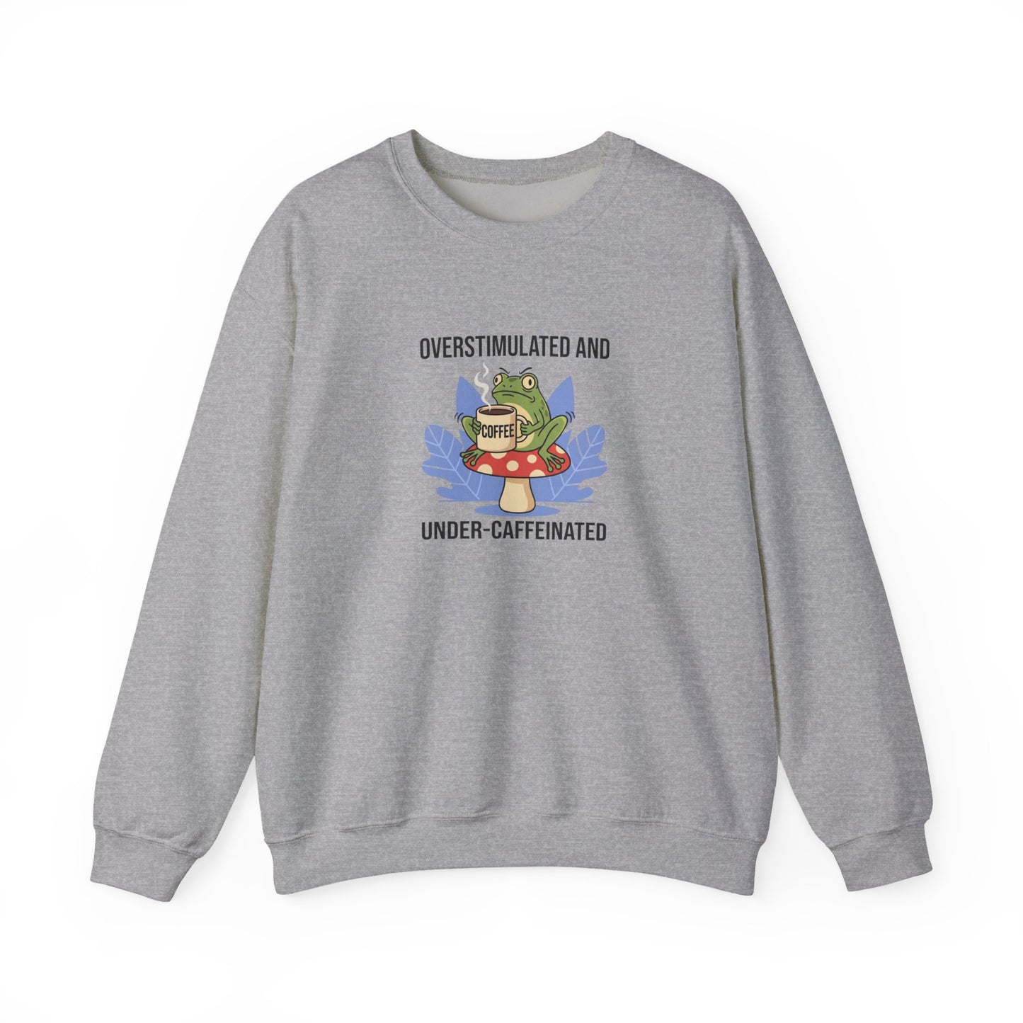 Gray sweatshirt with frog on mushroom drinking coffee, text "Overstimulated and Under-Caffeinated".