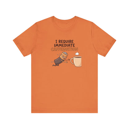 Orange t-shirt with cartoon battery and coffee cup, text "I REQUIRE IMMEDIATE CAFFEINATION".