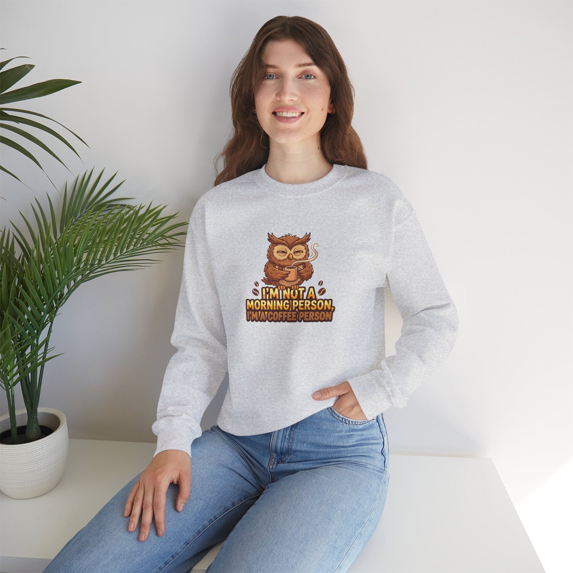 Grey crewneck sweatshirt with cartoon owl holding coffee mug and text.