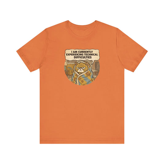 Orange t-shirt with a cartoon cat wrapped in a blanket saying "I am currently experiencing technical difficulties."