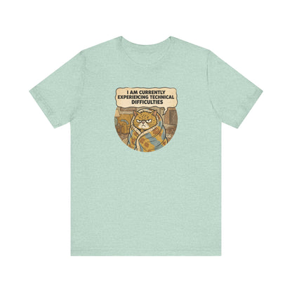 Mint t-shirt with a grumpy cat wrapped in a blanket, text reads "I AM CURRENTLY EXPERIENCING TECHNICAL DIFFICULTIES."