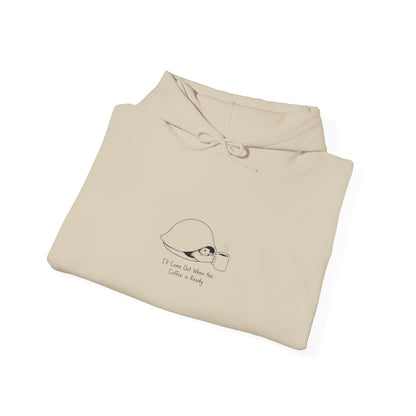 Cream hoodie with "I'll Come Out When The Coffee Is Ready" text and illustration.