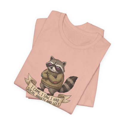 T-shirt with a grumpy raccoon wearing a sweater, text reads "I came, I saw, I had social anxiety and left".