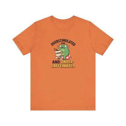 Orange t-shirt with graphic of an overstimulated, caffeinated frog holding coffee.