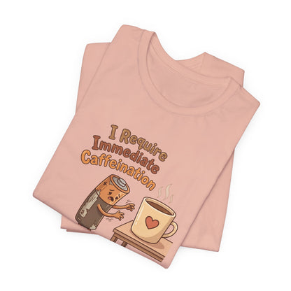 T-shirt with "I Require Immediate Caffeination" text and cartoon battery near coffee cup.