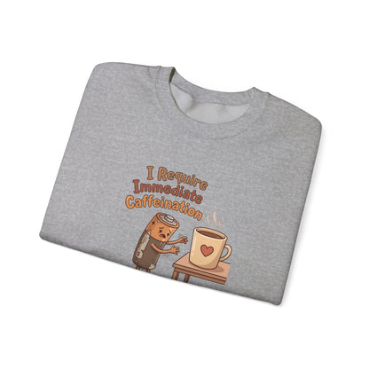 Gray sweatshirt with a cartoon battery reaching for a coffee mug.