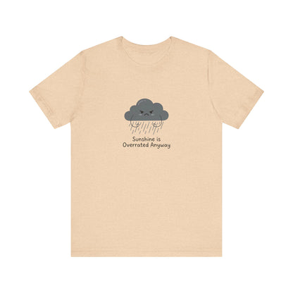 Light peach t-shirt with a cartoon cloud graphic saying "Sunshine is Overrated Anyway".