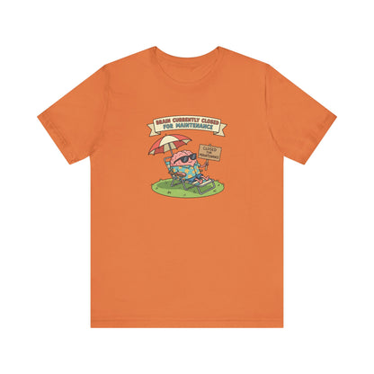 Orange t-shirt graphic of a cartoon brain relaxing on a lounge chair.