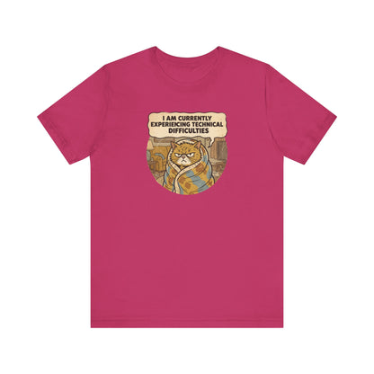 Fuchsia t-shirt with a cartoon cat wrapped in a blanket saying "I am currently experiencing technical difficulties."