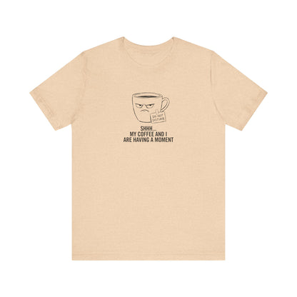 Light tan t-shirt with a grumpy coffee cup graphic and "DO NOT DISTURB SHHH... MY COFFEE AND I ARE HAVING A MOMENT" text.